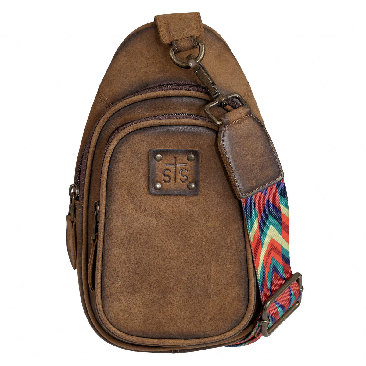 Brown leather sling bag with colorful nylon strap, zip pockets and brown leather patch with STS Ranchwear logo embossed.