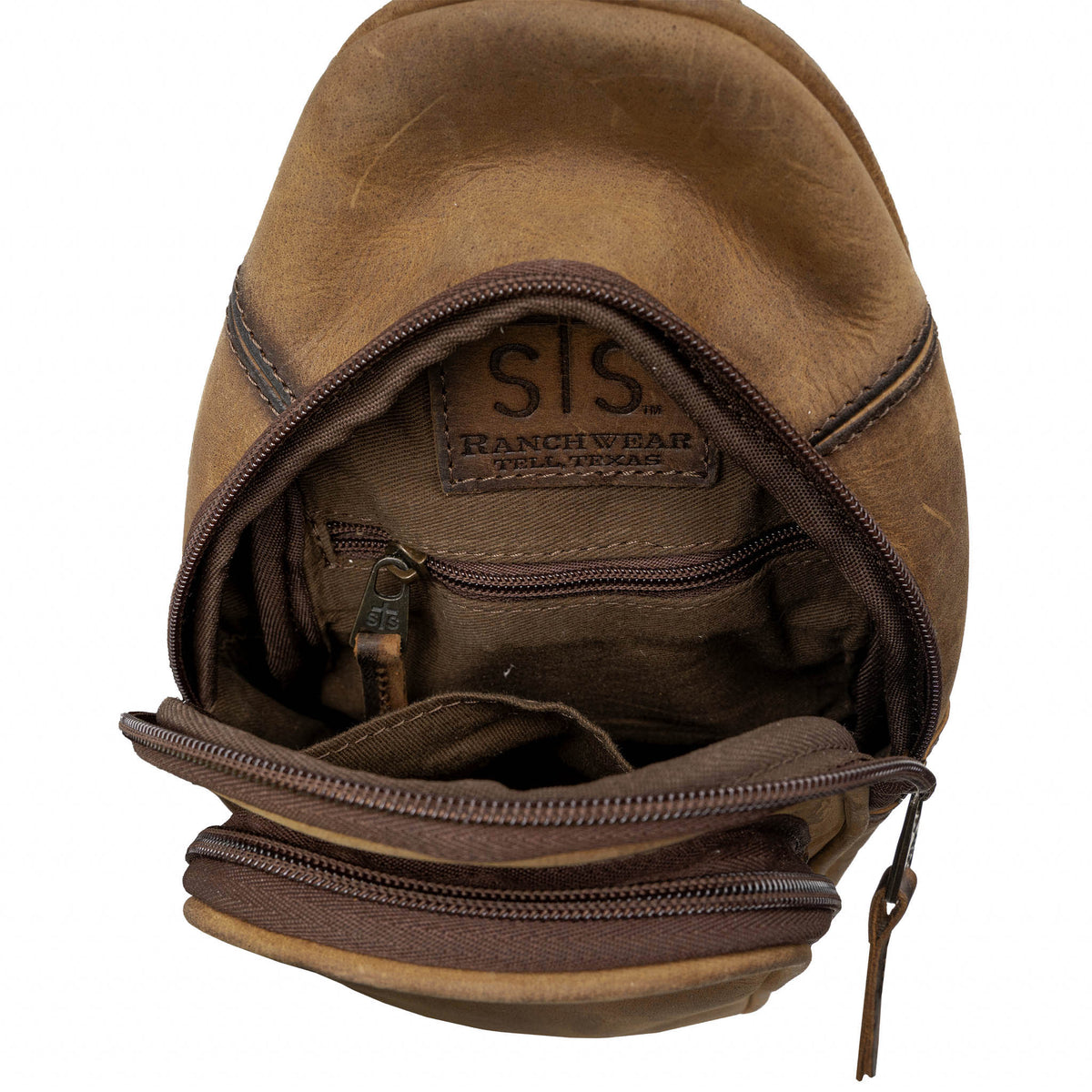 Interior of brown leather sling bag with zip and slip pockets.