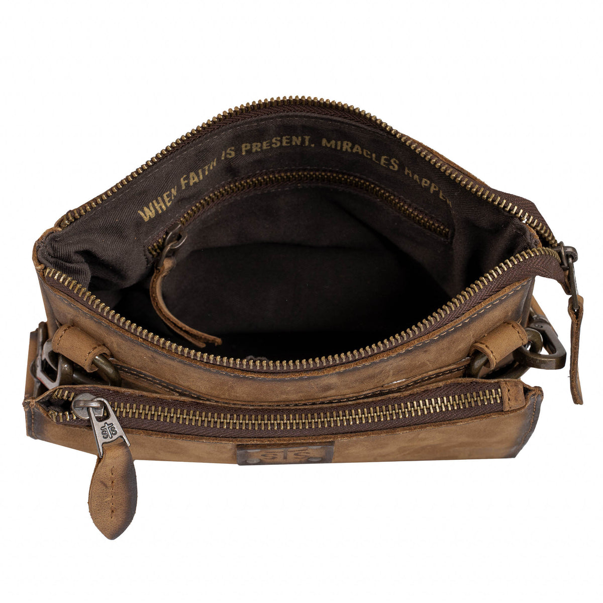 Interior of brown crossbody bag with zip top closure and pocket.