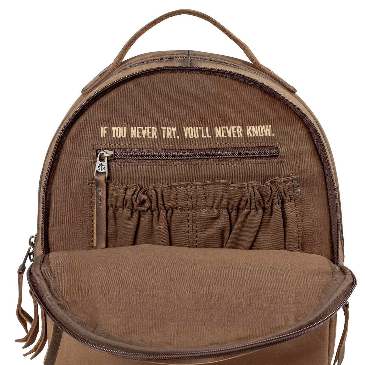Inside view of brown genuine leather backpack with brown lining, scrunch pockets, zip closure pocket and inspirational quote "If you never try, you'll never know.".
