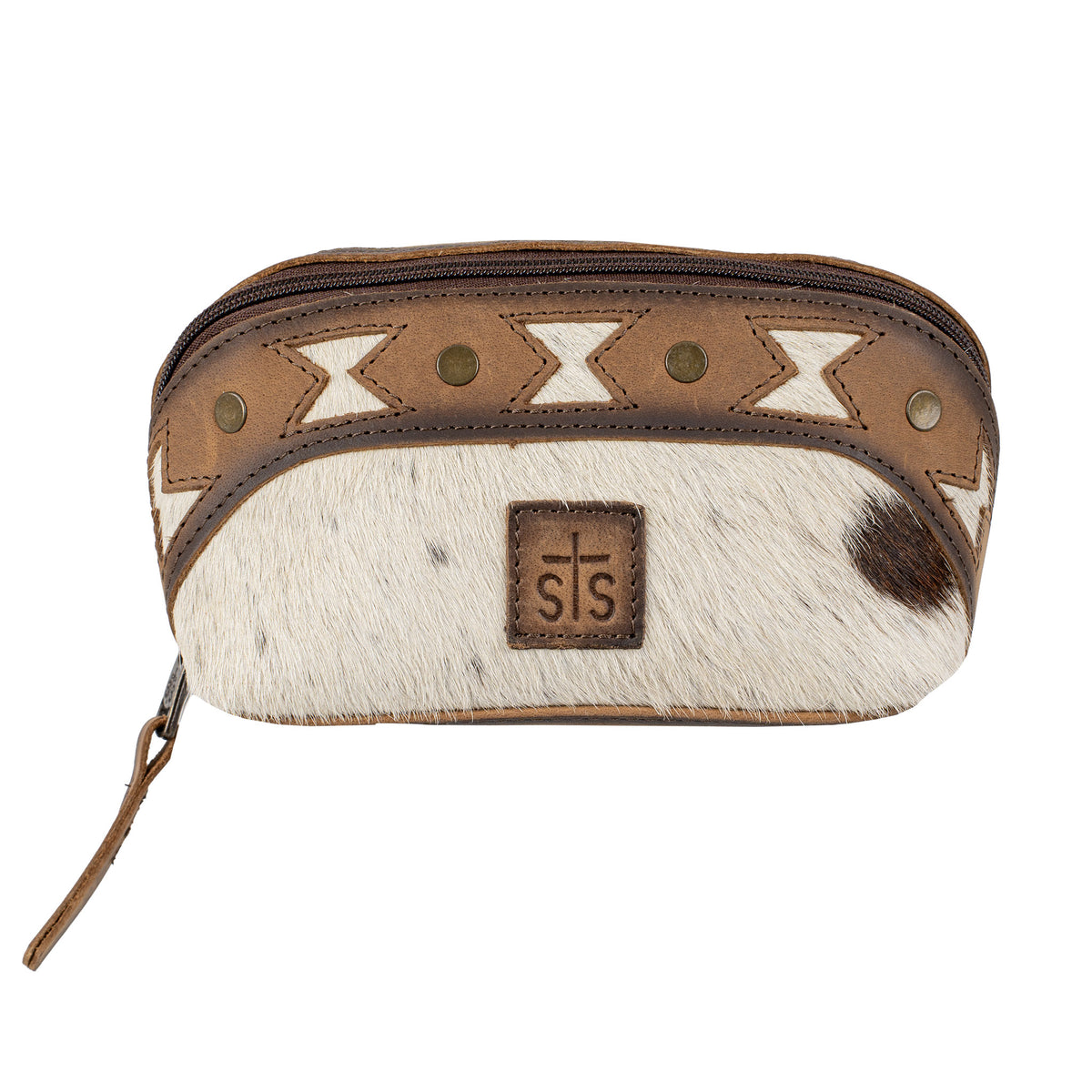 A makeup pouch with a mix of brown full grain leather and cowhide accents, featuring geometric aztec cut-outs, brown leather patch with STS Ranchwear embossed logo and zip top closure.