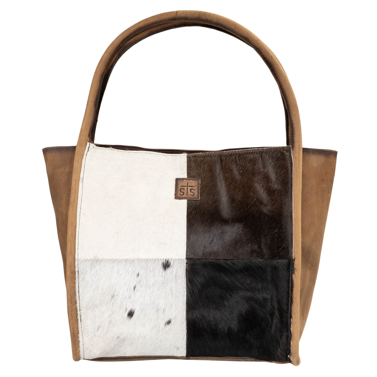 Genuine leather tote bag with brown and white hair on hide cowhide accents and dual rolled leather handles displayed on a white background.