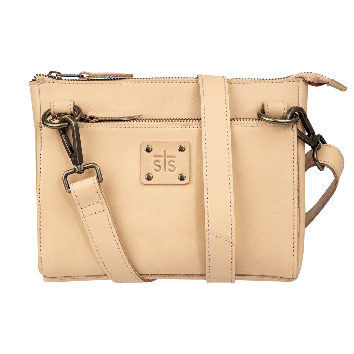 A beige leather crossbody with a top and front zip closure, a leather strap, and an STS branded leather patch on a white background.