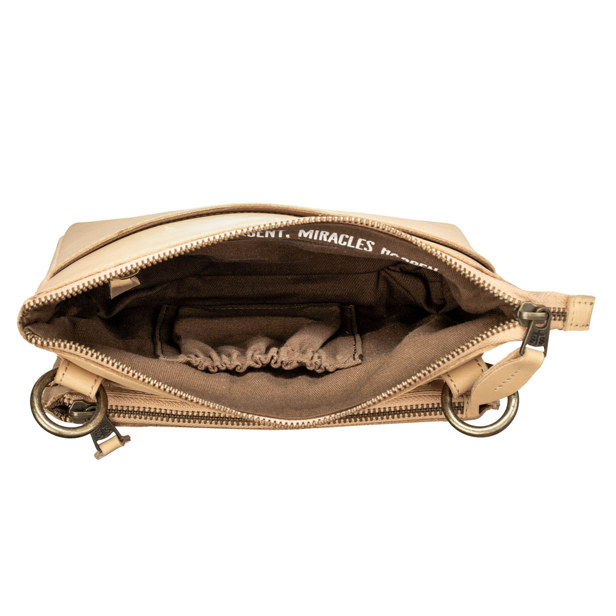 An above open view of a beige leather crossbody with a top and front zip closure on a white background.