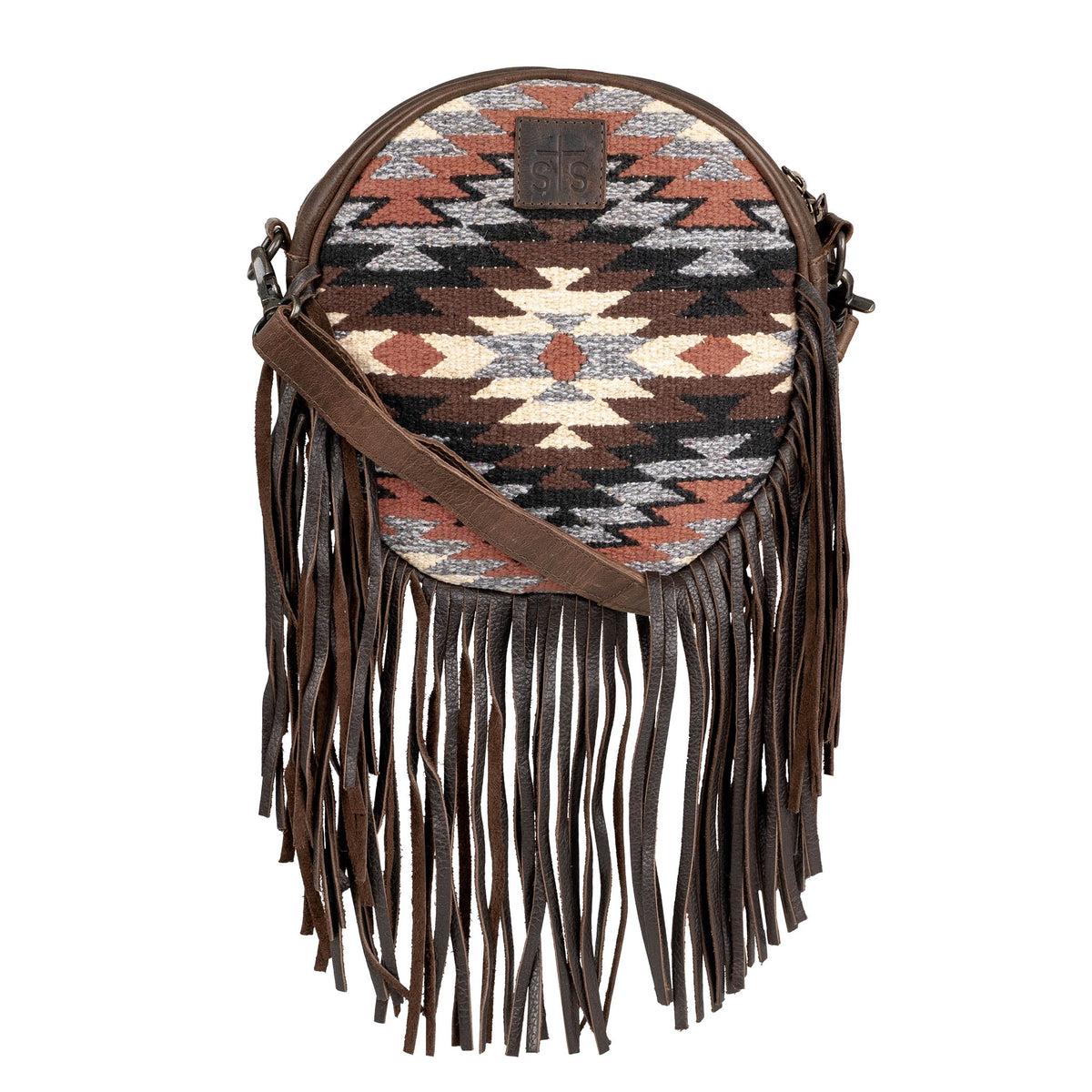 Round leather handbag with aztec pattern, leather fringe and crossbody strap.