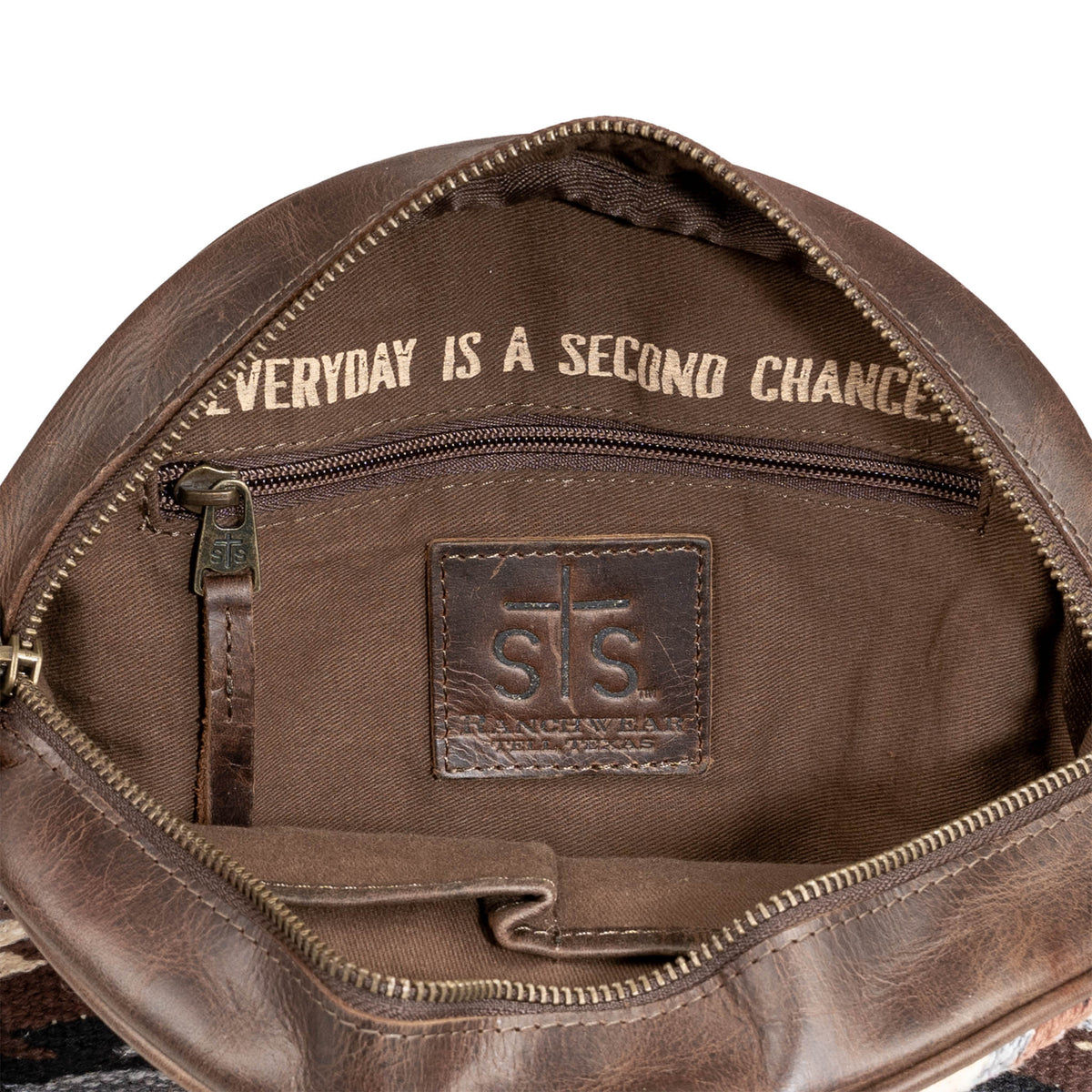 Brown leather bag with 'Everyday is a Second Chance' text and STS logo.