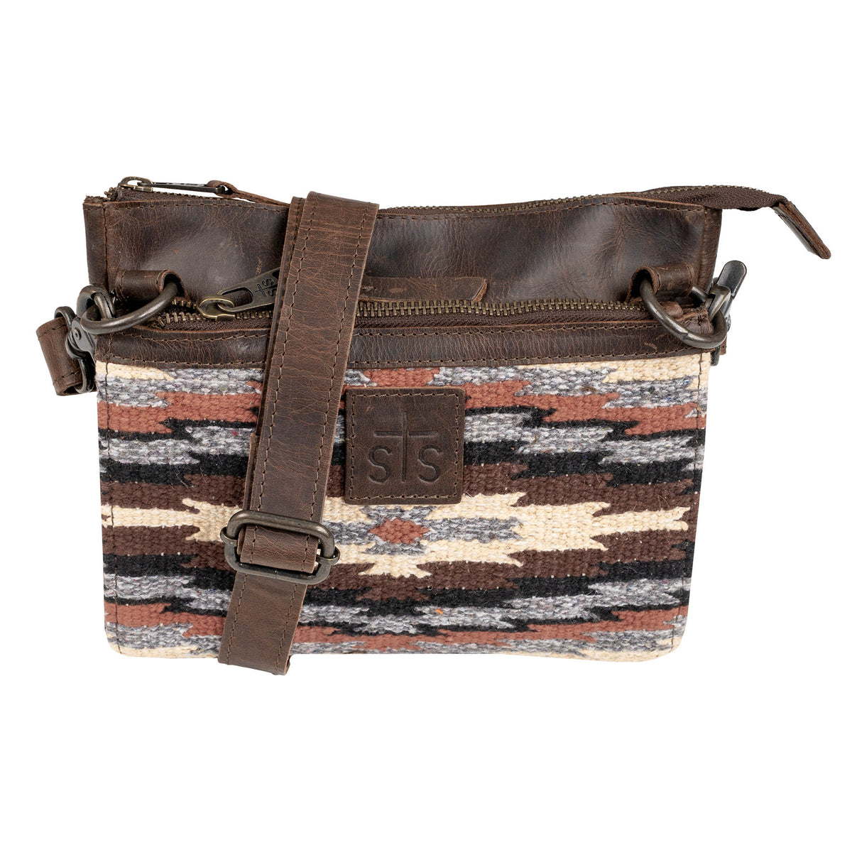Crossbody bag with aztec pattern, leather strap and brown leather accents on a white background.
