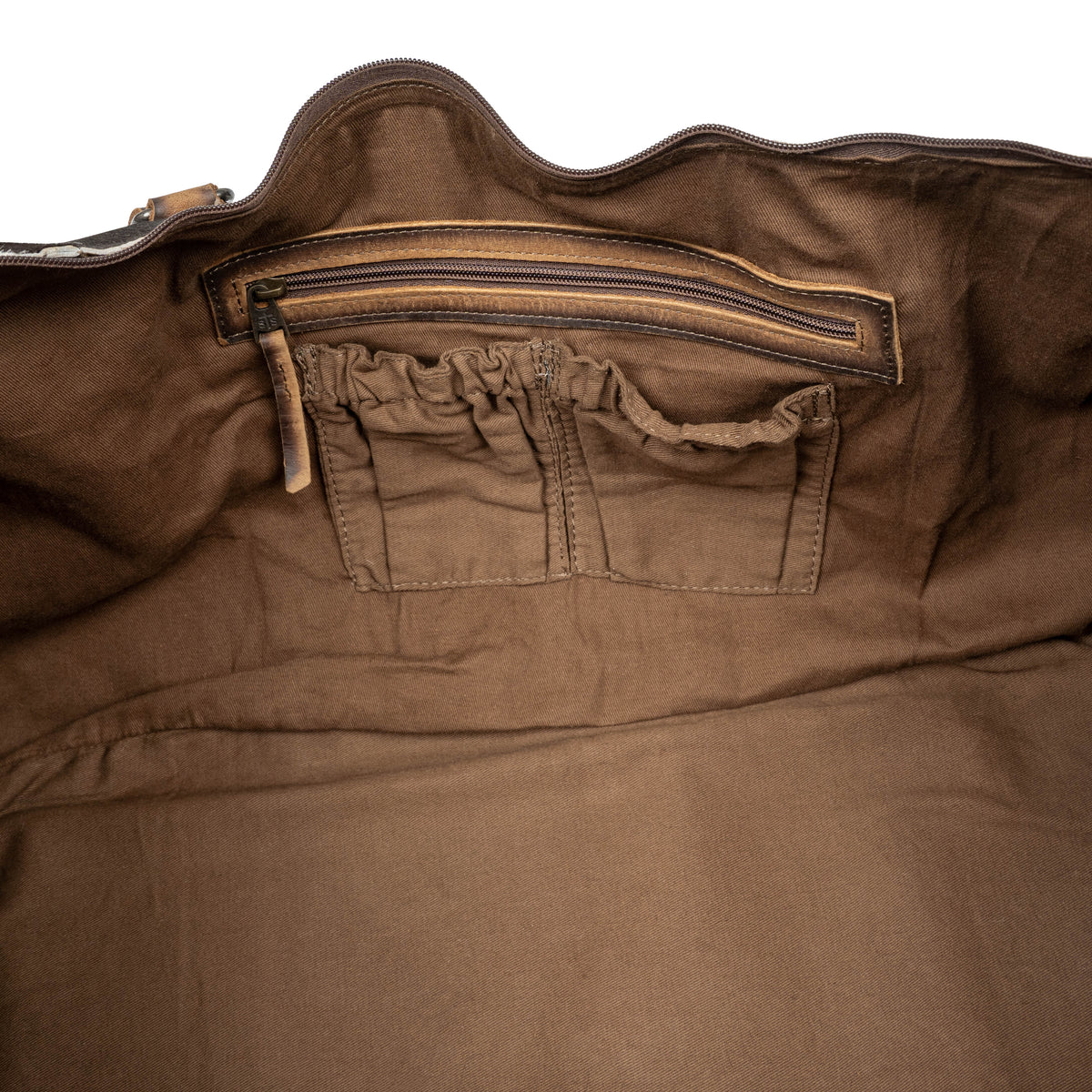 Interior of cowhide duffle with zip and scrunch pockets.