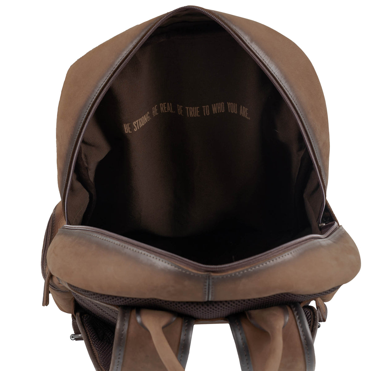 Interior of brown leather backpack with zip closure main compartment and brown lining.