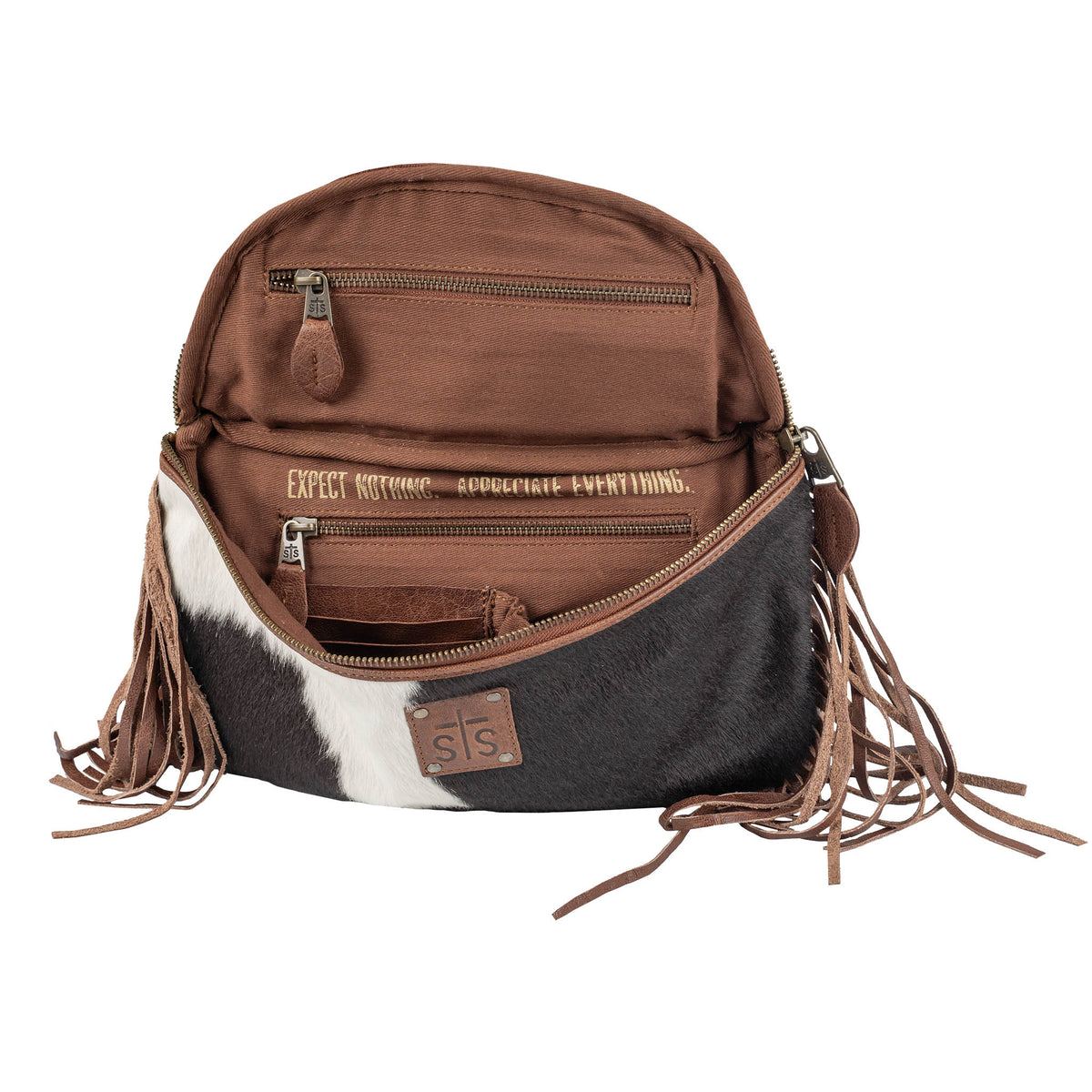 Brown and black cowhide belt bag with fringe details on a white background.