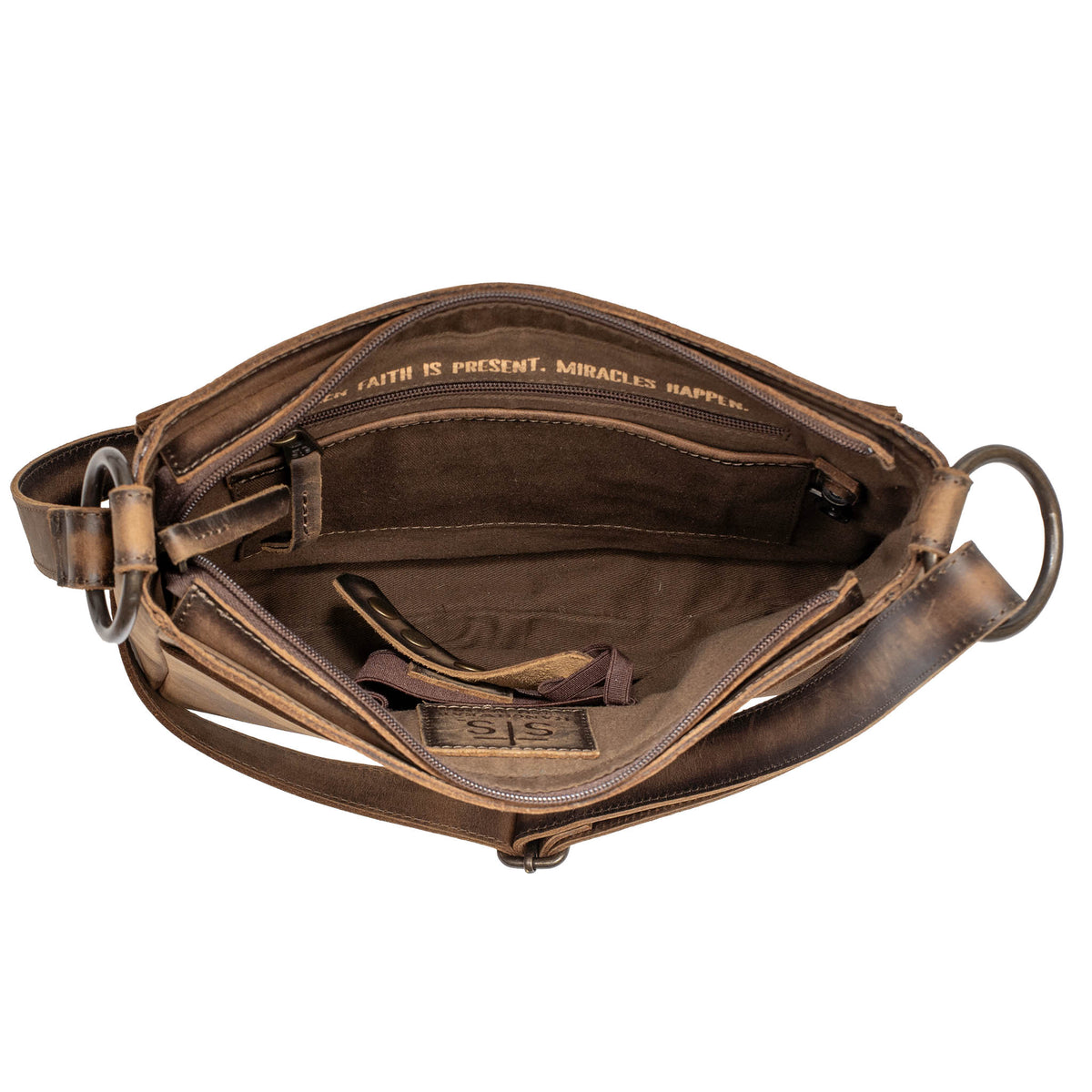 Over head inside view of the storage of leather crossbody purse on a white background.