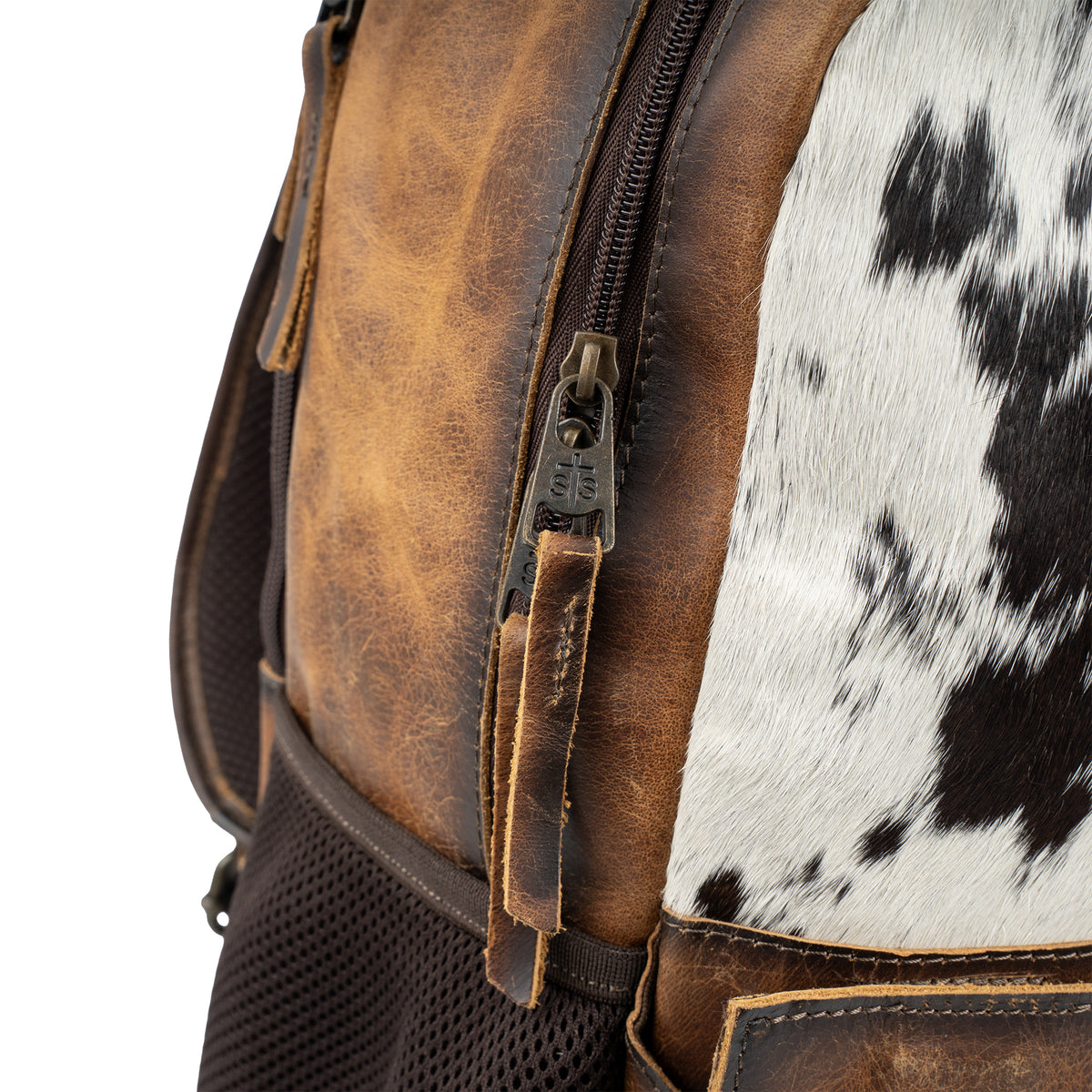 closeup of the zip closure of our distressed full grain leather and cowhide backpack with double zip around closure, top carry handle and adjustable straps on white background