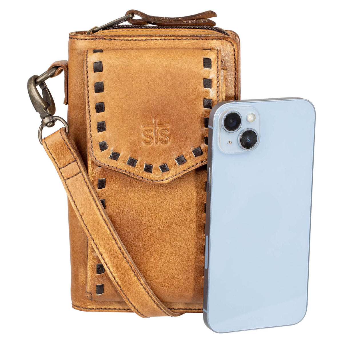 A closeup of phone next to a Bandera tan leather phone sling wallet with buckstitch, zip around closure, magnetic flap for phone, and adjustable crossbody strap on white background.