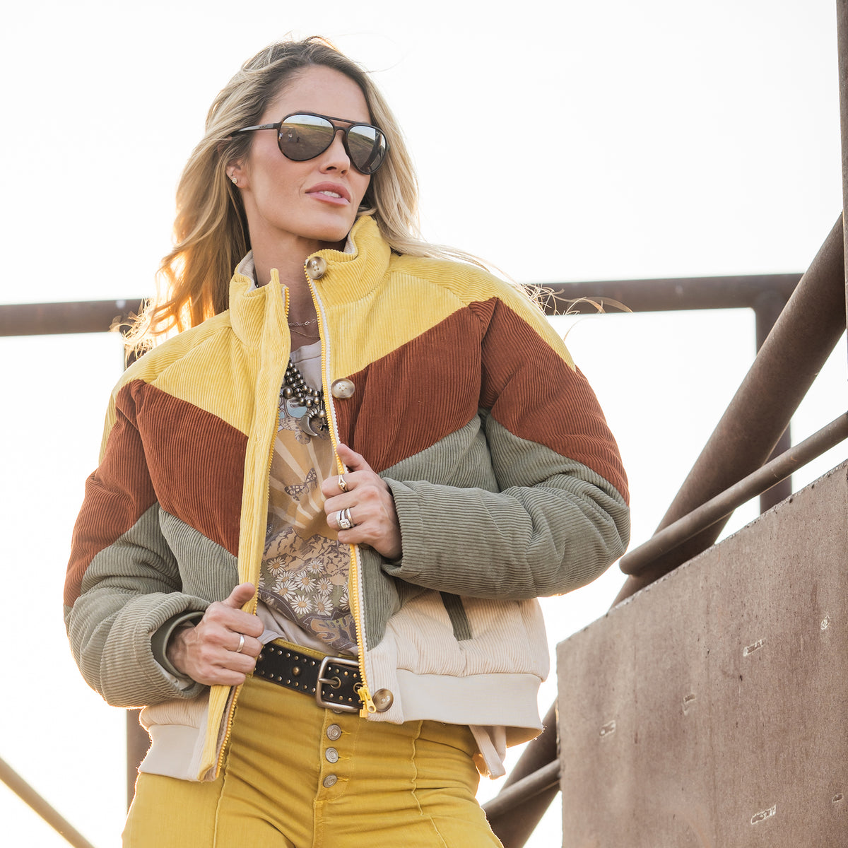 Terryn Cooper wearing our cotton color block bomber with zip and button closure outside