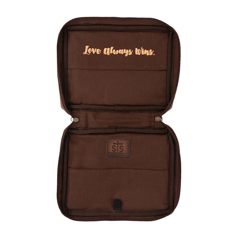 Inside of a hair on hide cowhide Bible cover with "Love always wins." message on a white background.