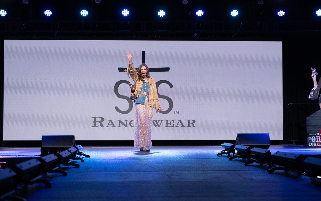 Jen Smith wearing a tan leather jacket with fringe on the runway at the Pro Rodeo League Women’s Style Show and Luncheon, held at the South Point Casino in Las Vegas during the 2025 National Finals Rodeo.