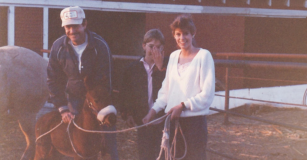 Jen Smith with her father holding the reins for a brown pony.