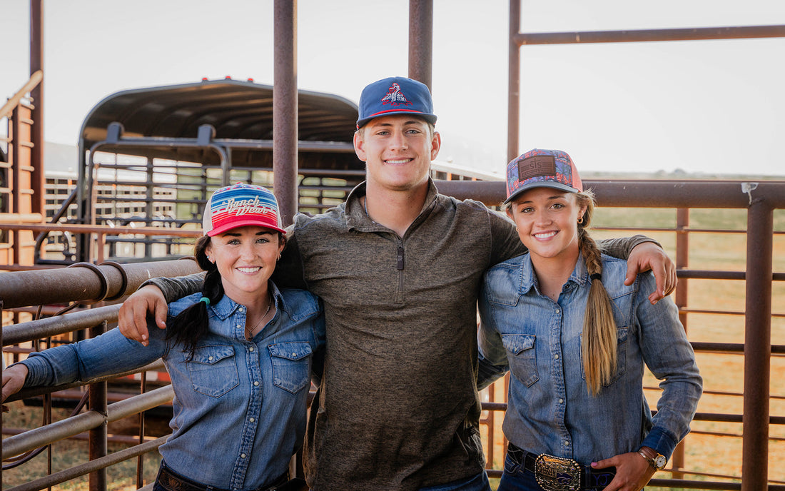 Man with arms around two women standing on a ranch in Tell, Texas.