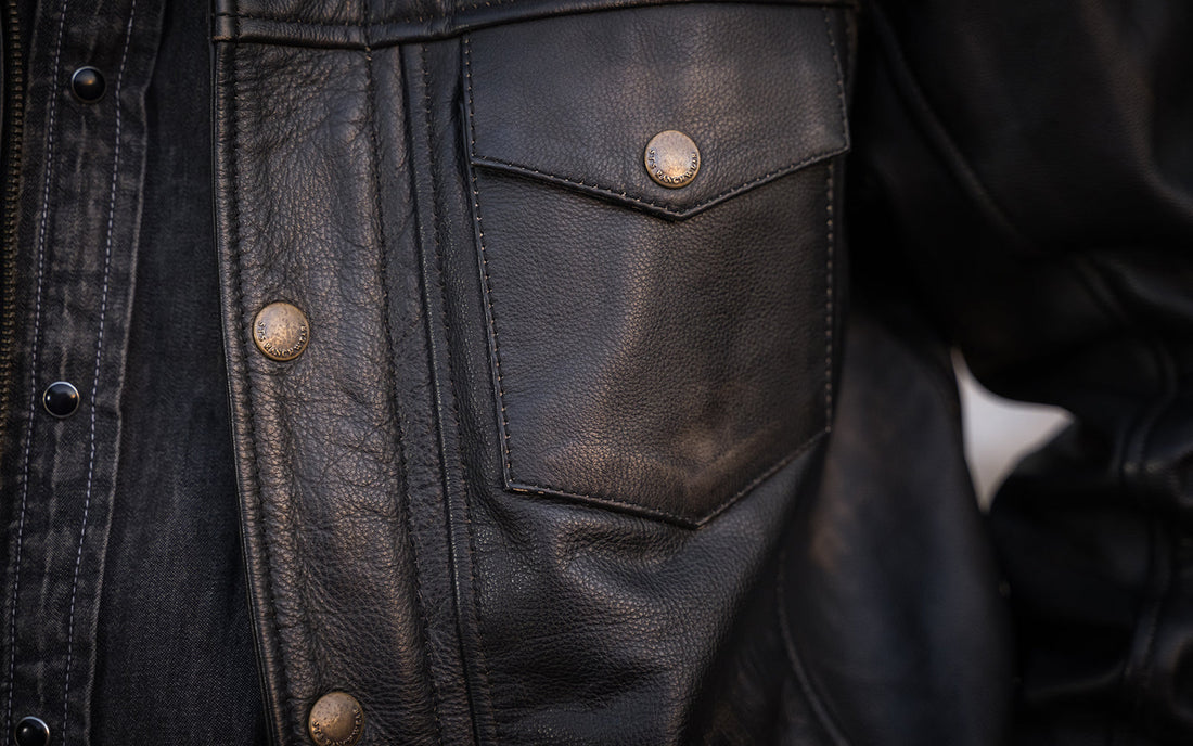Brown leather jacket with bronze zipper and button.