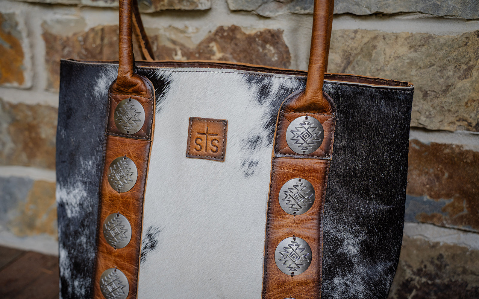 Shop STS Ranchwear's Vaquero Cowhide collection of hair on hide handbags and wallets.