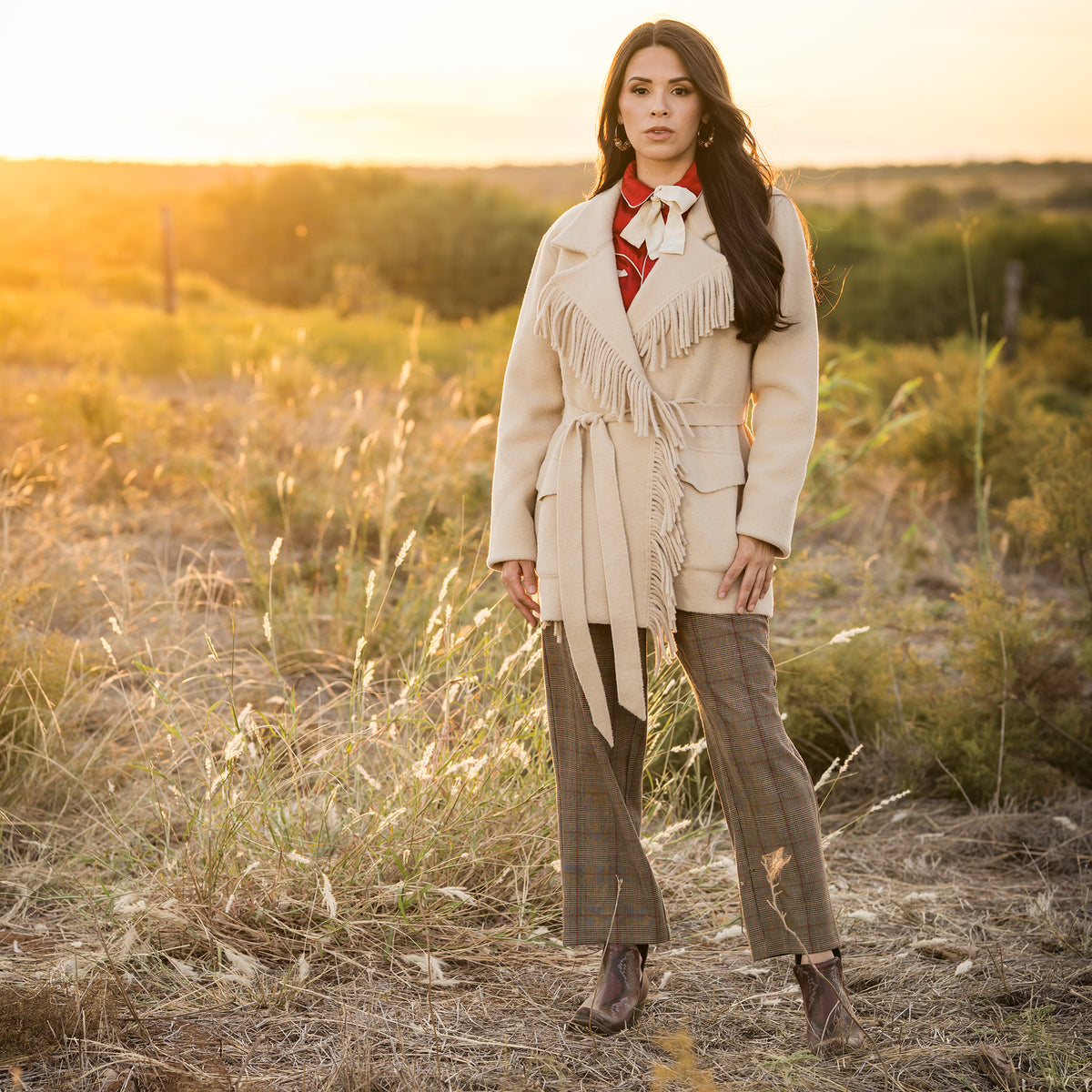 Soni Vest wearing our beige lapel collared jacket with open front with waist tie belt outside