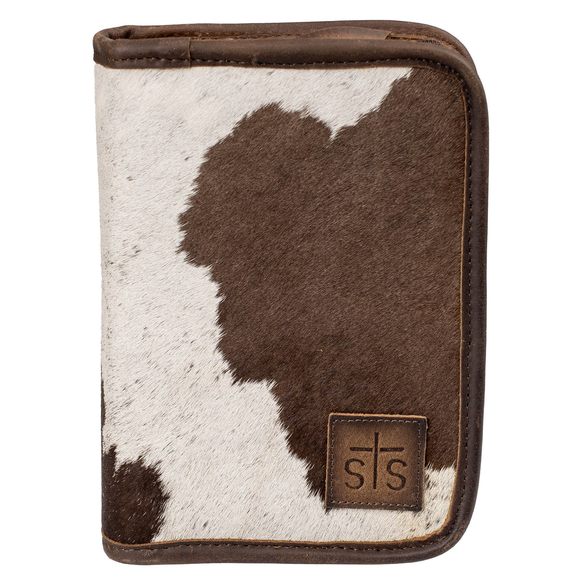 Hair on hide cowhide zip closure jewelry case with brown and white accents and a leather STS branded patch in bottom right corner on a white background.