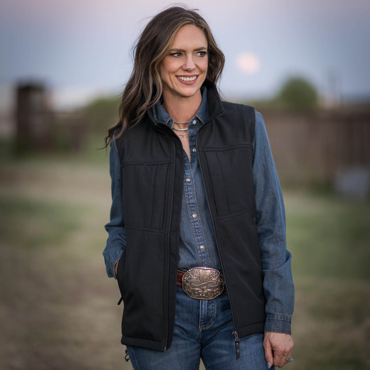 Jennifer Smith wearing a Black zip up vest over a long sleeve denim shirt on STS Ranch.