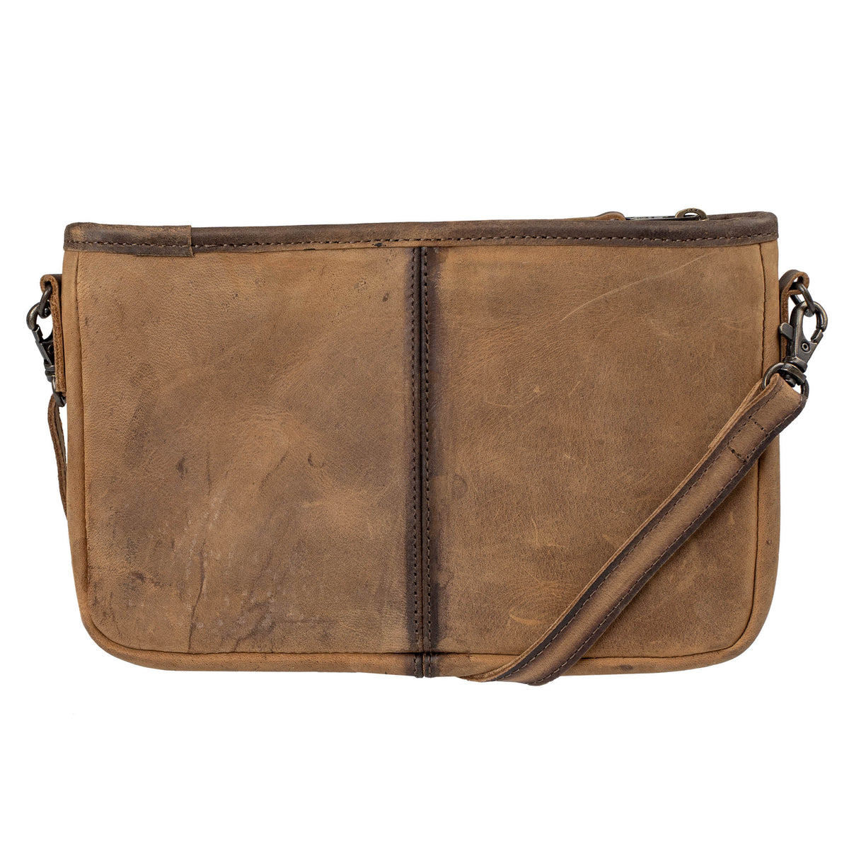 Back of a hair on hide cowhide crossbody bag with cowhide pattern and brown leather accents and a brown leather crossbody strap on a white background.