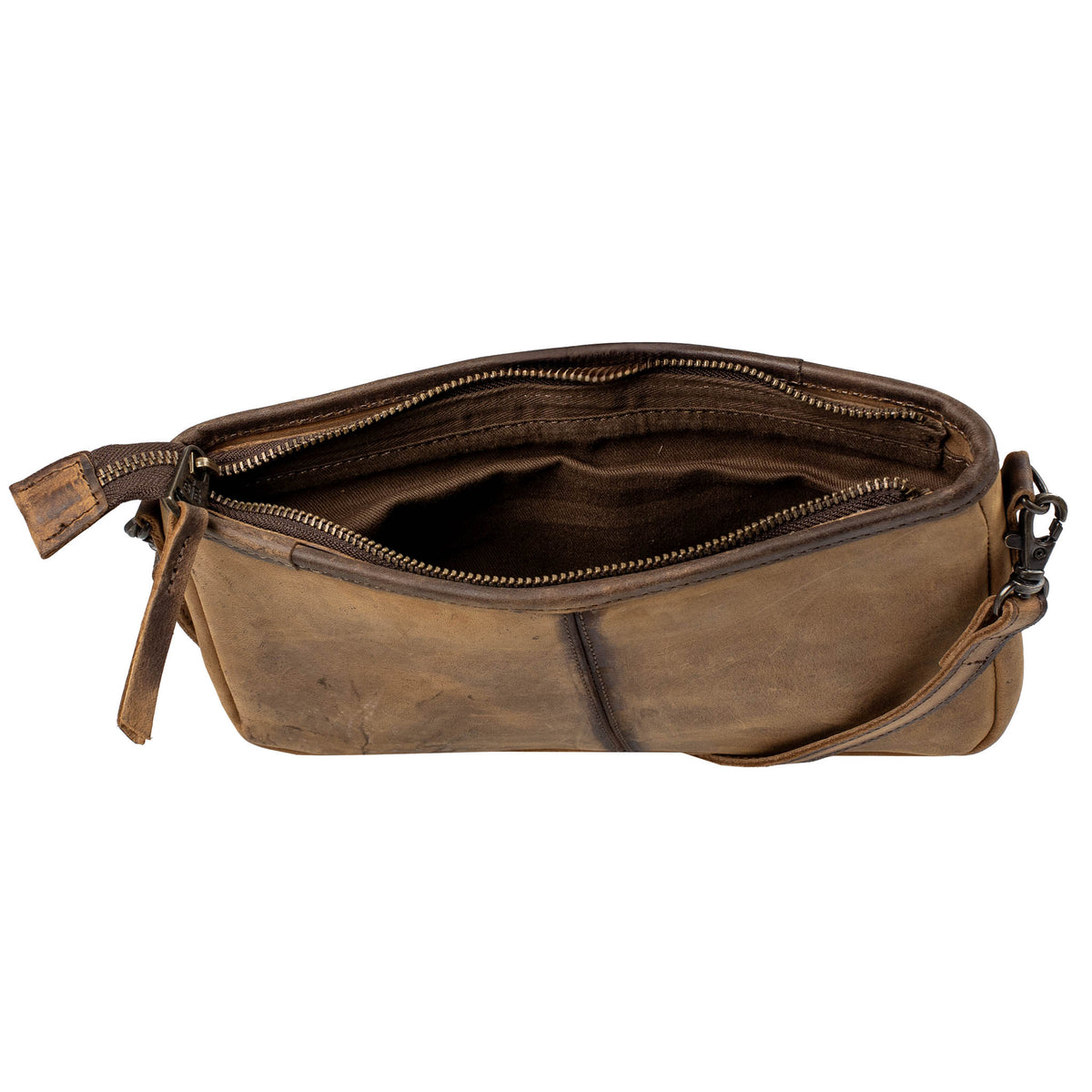 Inside of a hair on hide cowhide crossbody bag with cowhide pattern and brown leather accents, zip closure and interior brown lining on a white background.