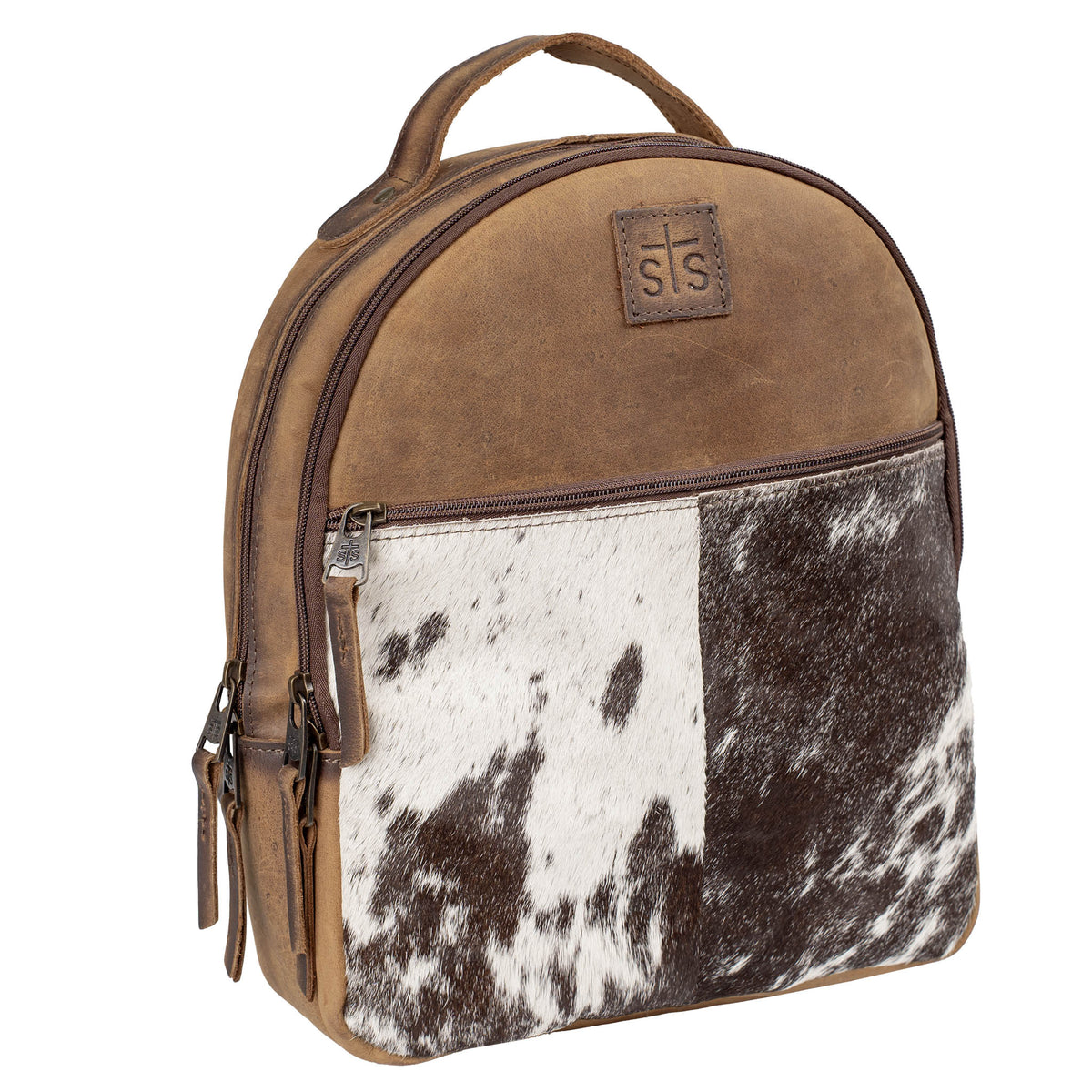Backpack with brown genuine leather and brown and white hair on hide cowhide pattern, zip around closure, 1 zip closure pocket and a leather carrying handle on top on a white background.