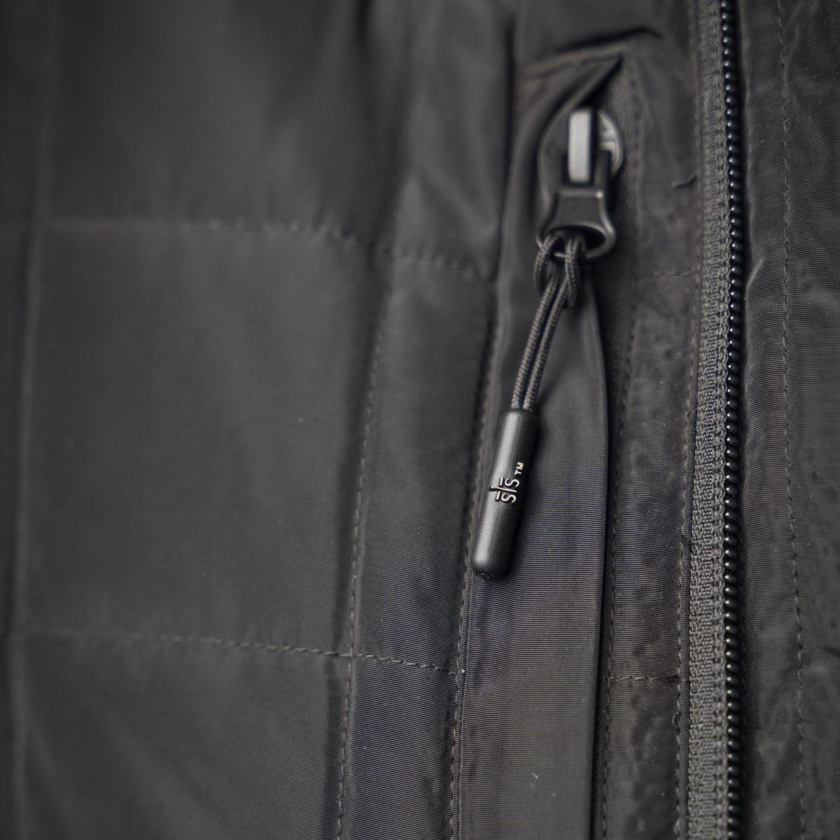 closeup of the front zipper pocket of our black vest with double zip closure and classic western yoke accents