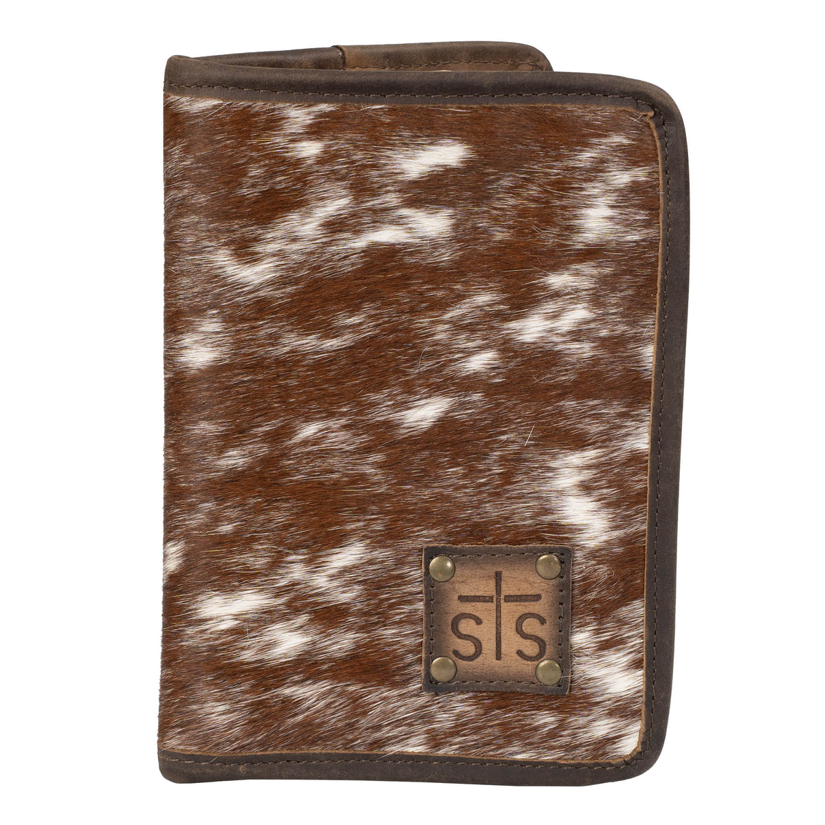 Hair on hide cowhide magnetic closure wallet with brown and white accents and a leather STS branded patch in bottom right corner on a white background.