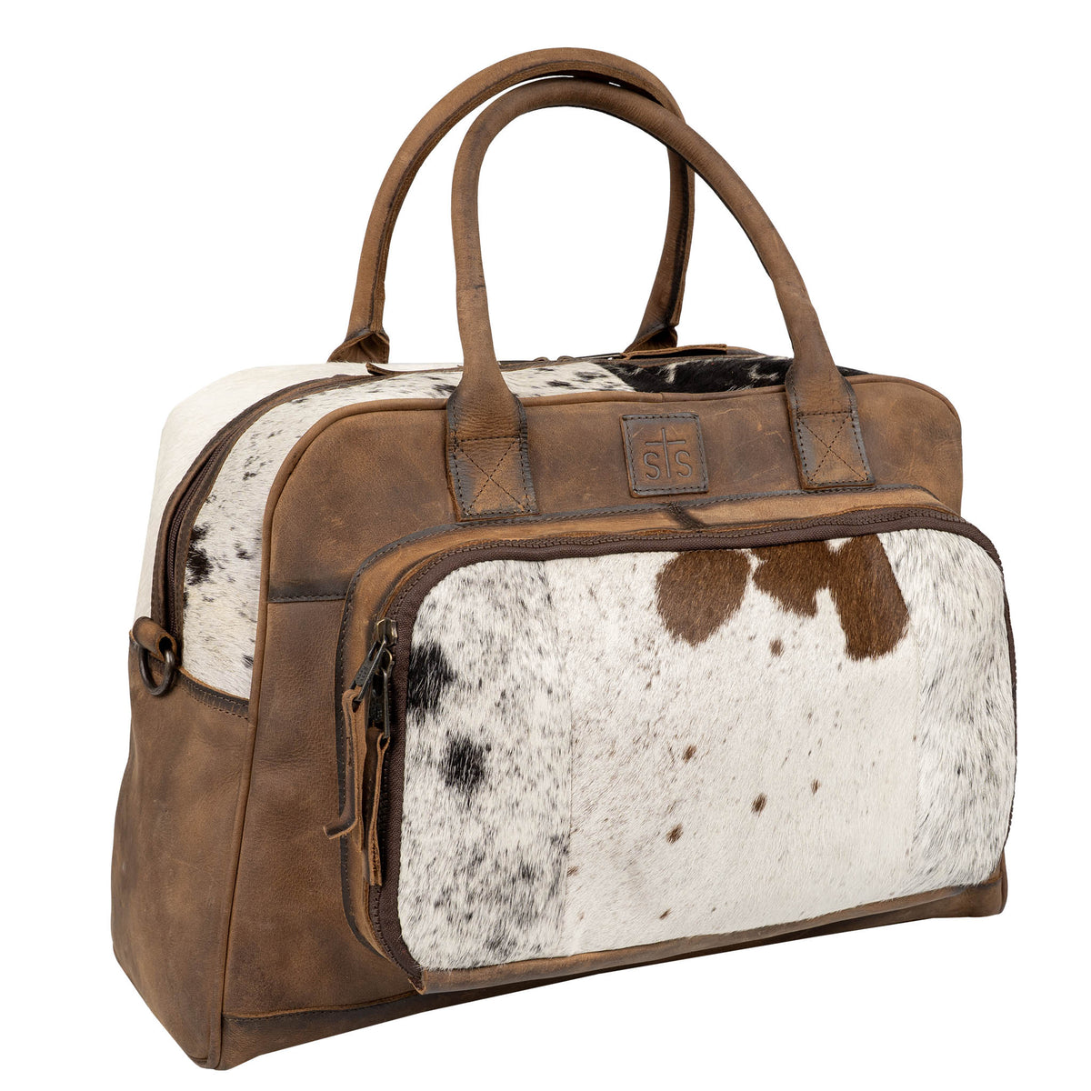 Brown and white cowhide patterned bag with leather accents, zip closure and dual rolled leather handles on a white background.