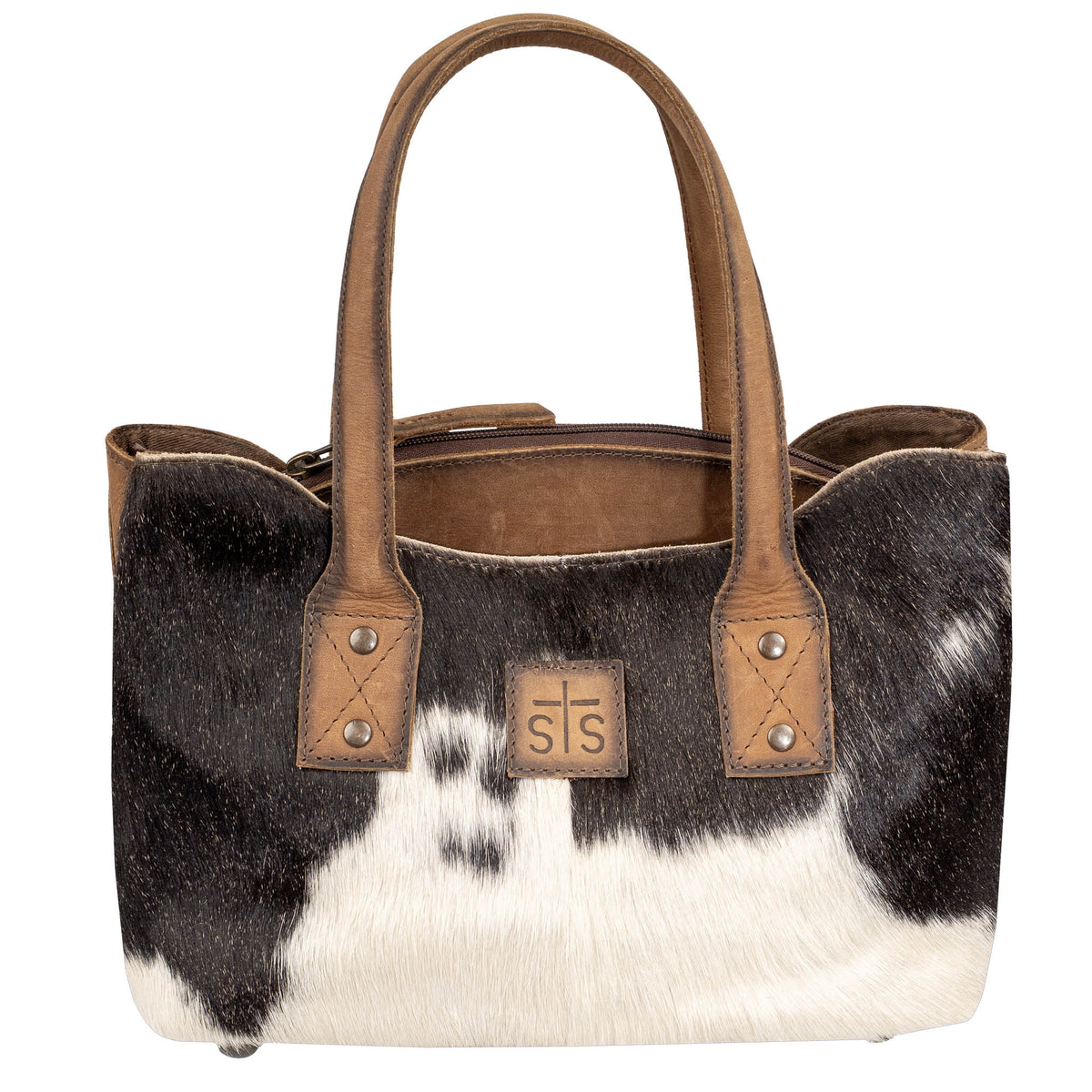 A cowhide and leather purse with two carry handles and a center zip closure on a white background