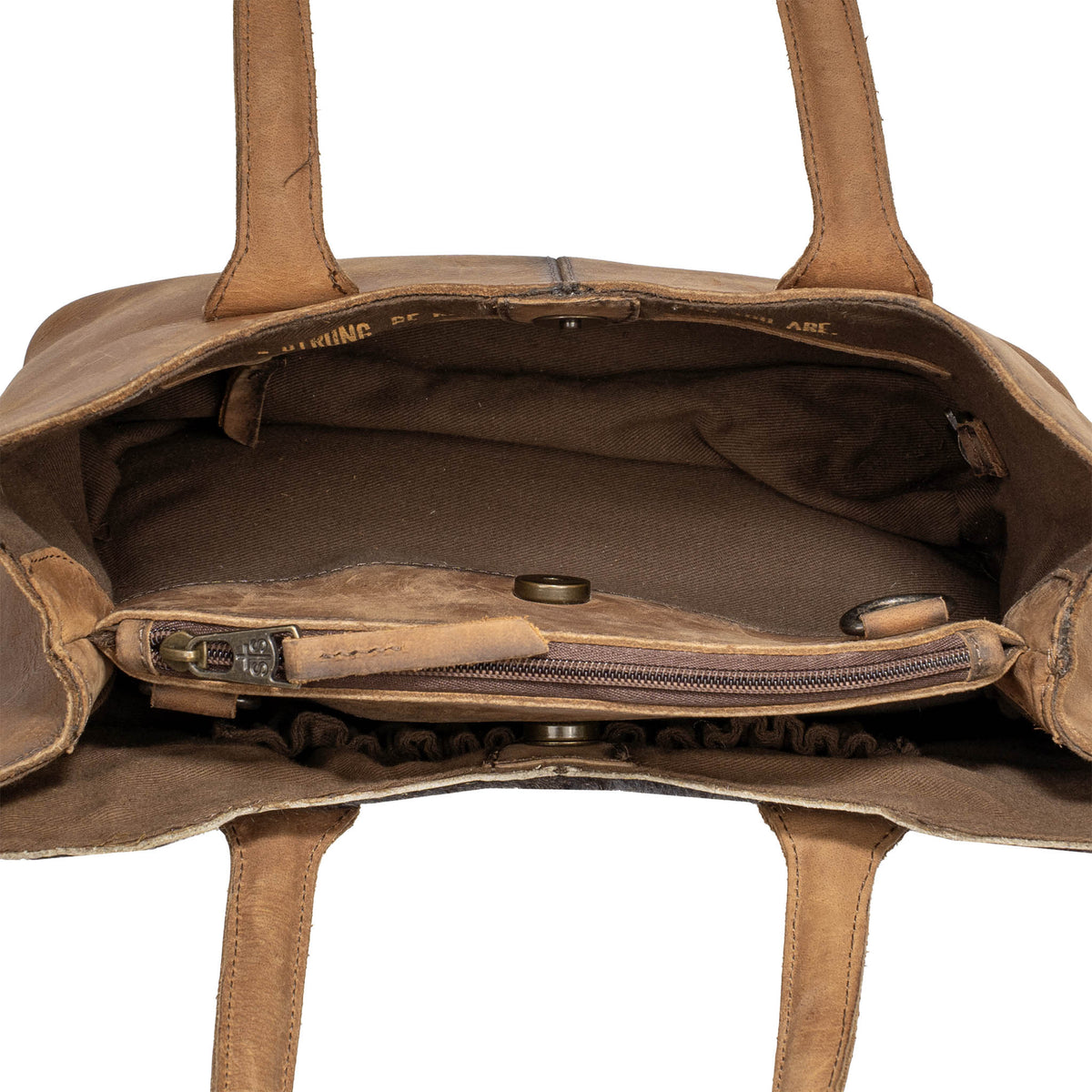 Inside overhead view of a leather purse with half of the bag unsnapped on a white background