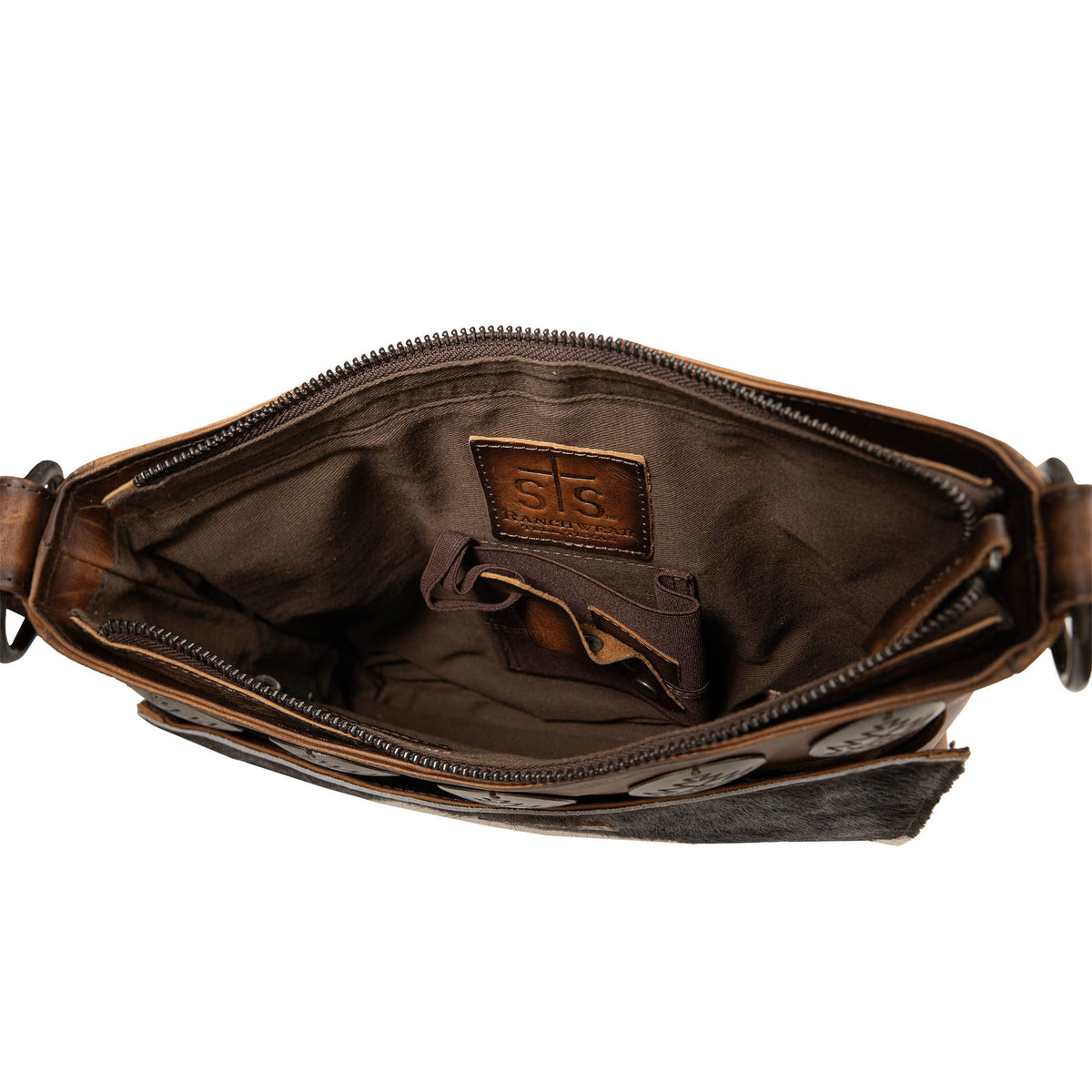 Inside of leather crossbody with zip top closure and concealed carry pocket.