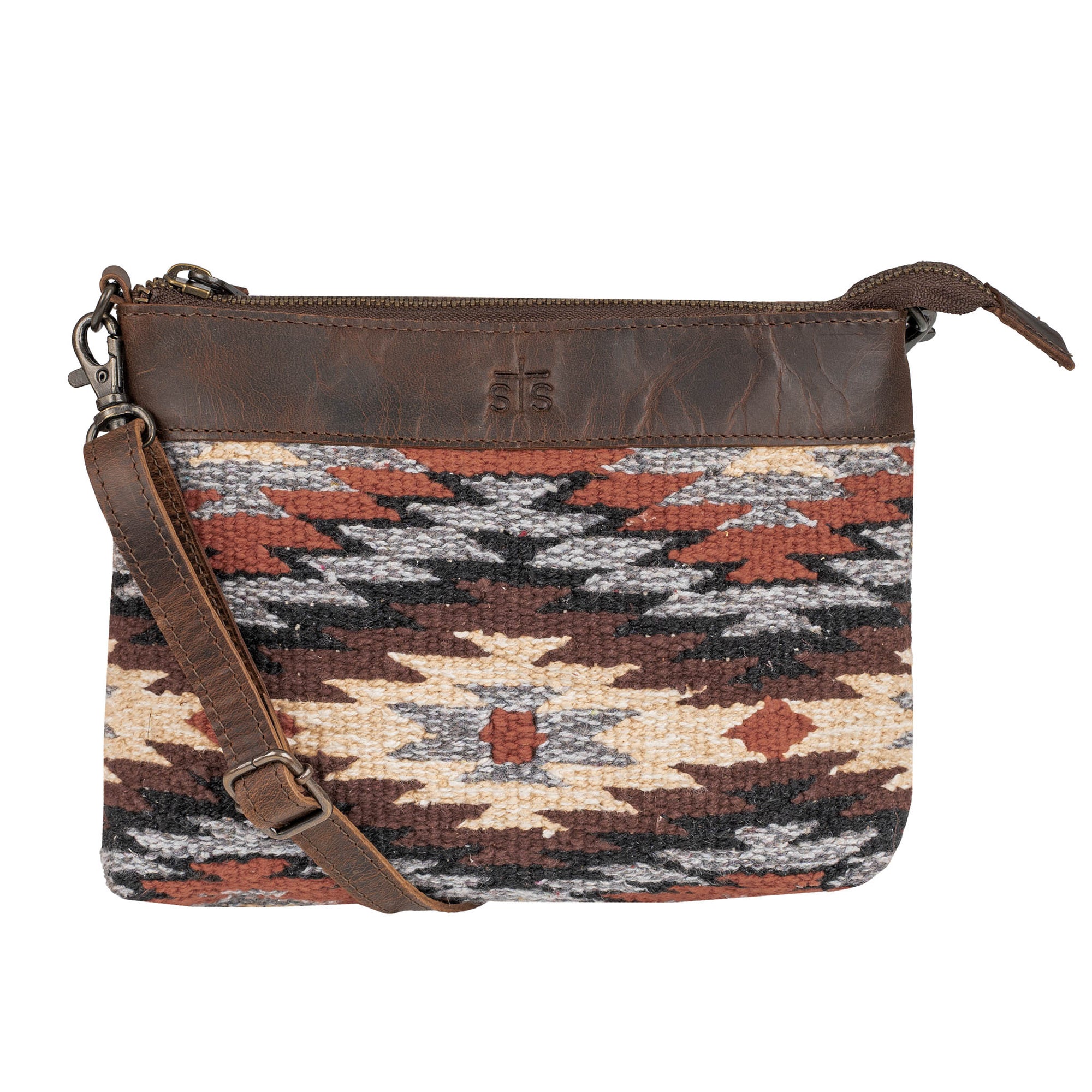 Patterned handbag with brown strap on a white background