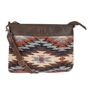 Patterned handbag with brown strap on a white background