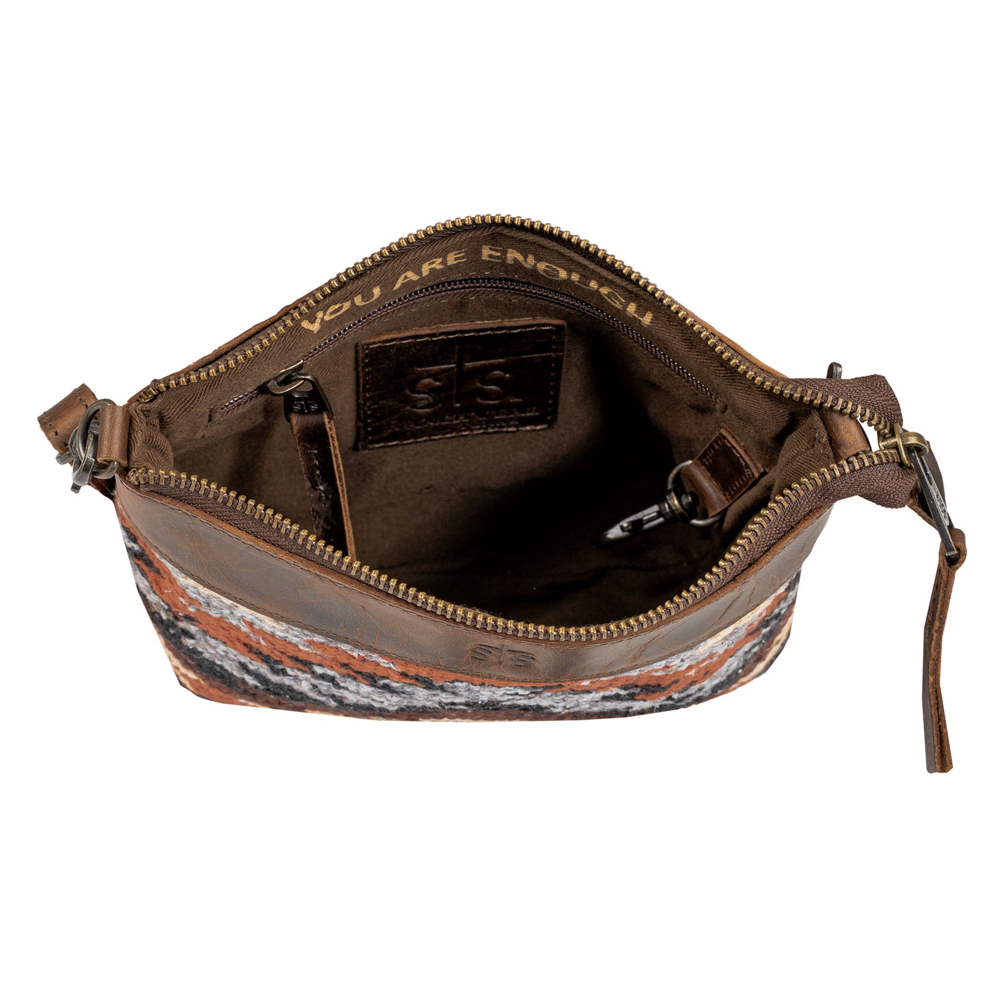 Brown leather crossbody bag with patterned bottom on a white background