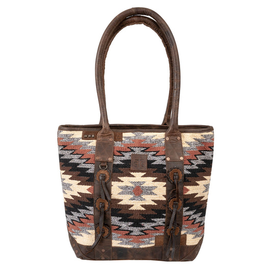 Tote bag with aztec patterned and brown leather handles on a white background.