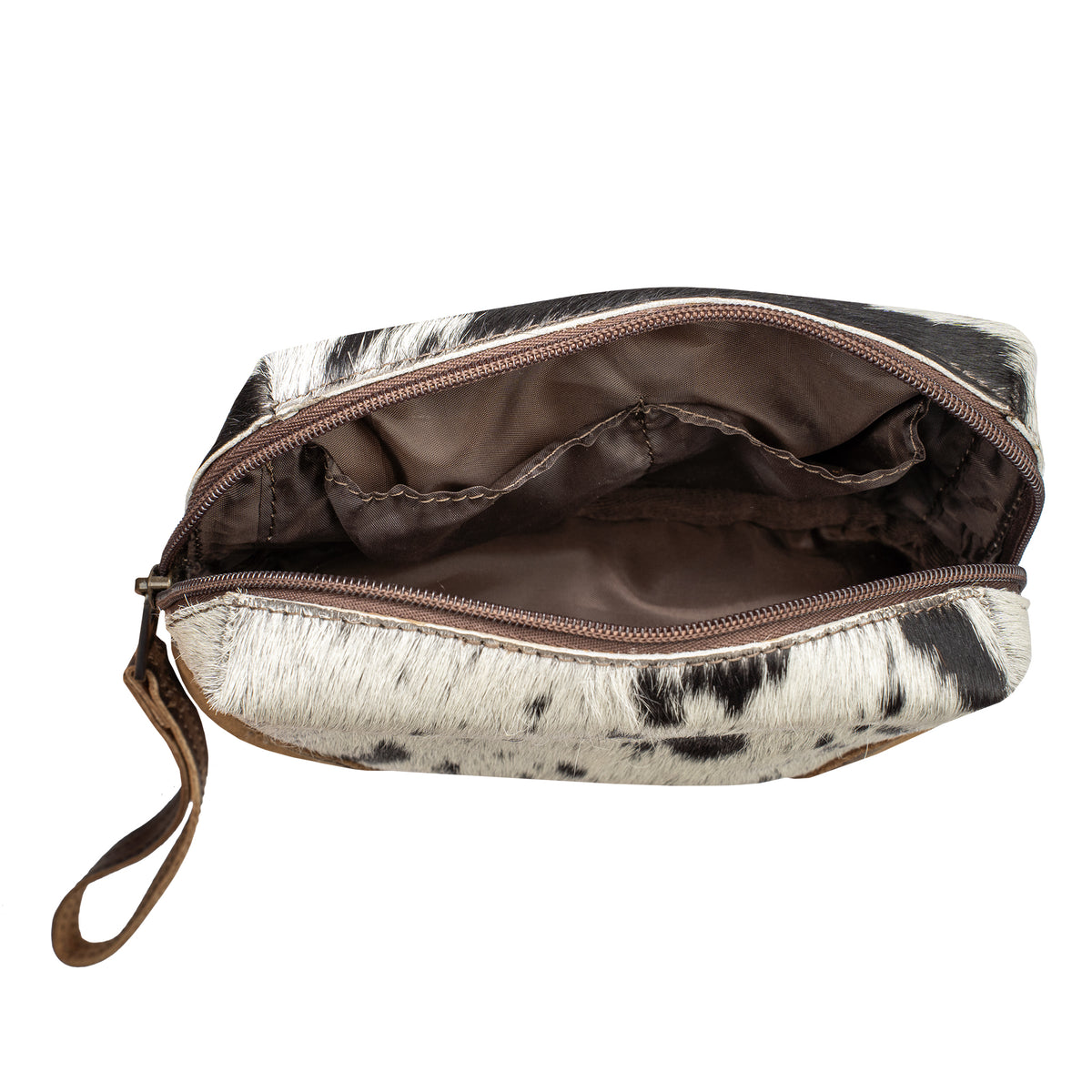 An open zippered cosmetic pouch with a black and white cowhide pattern, brown interior lining and main compartment.
