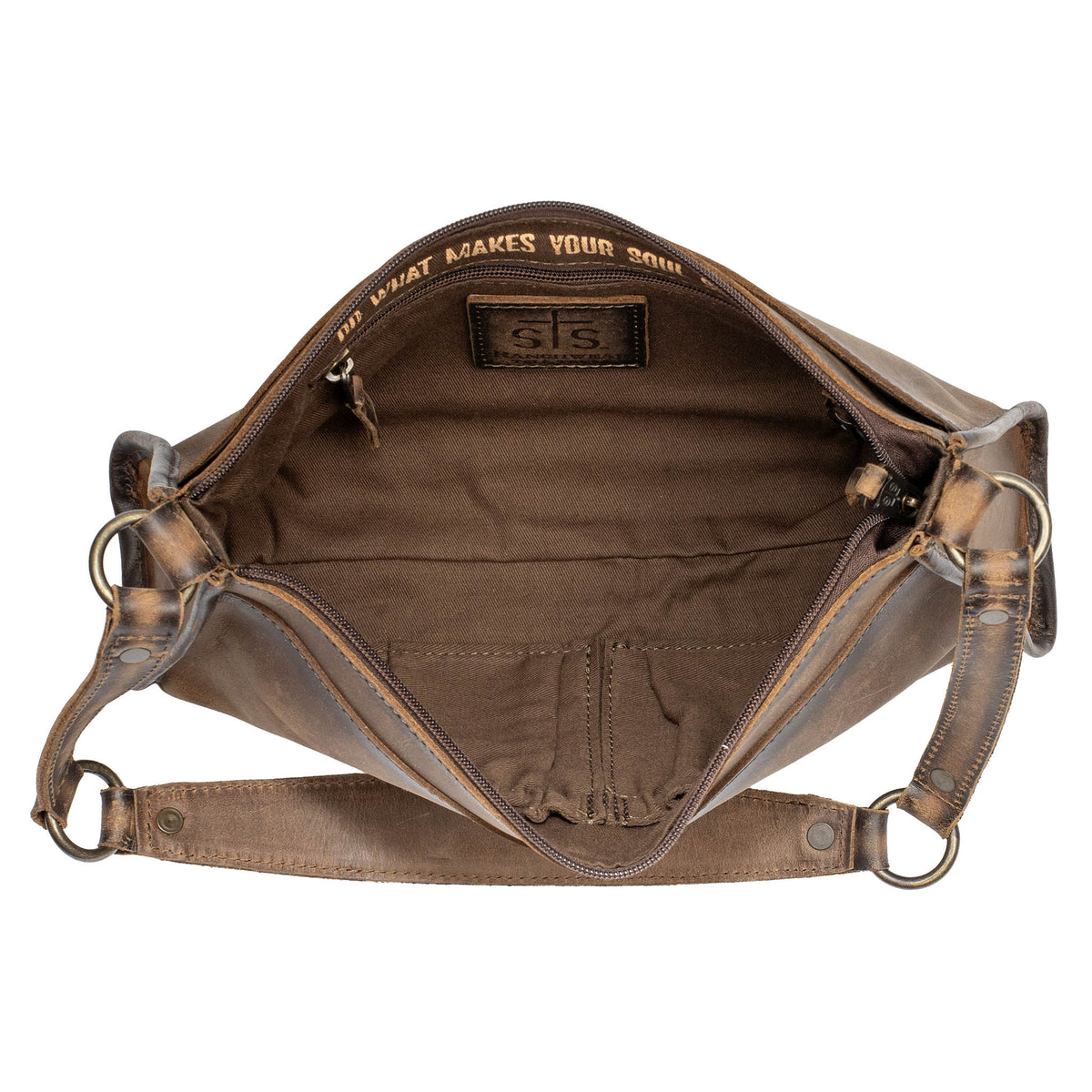 Overhead open view of a leather shoulder bag on a white background. 