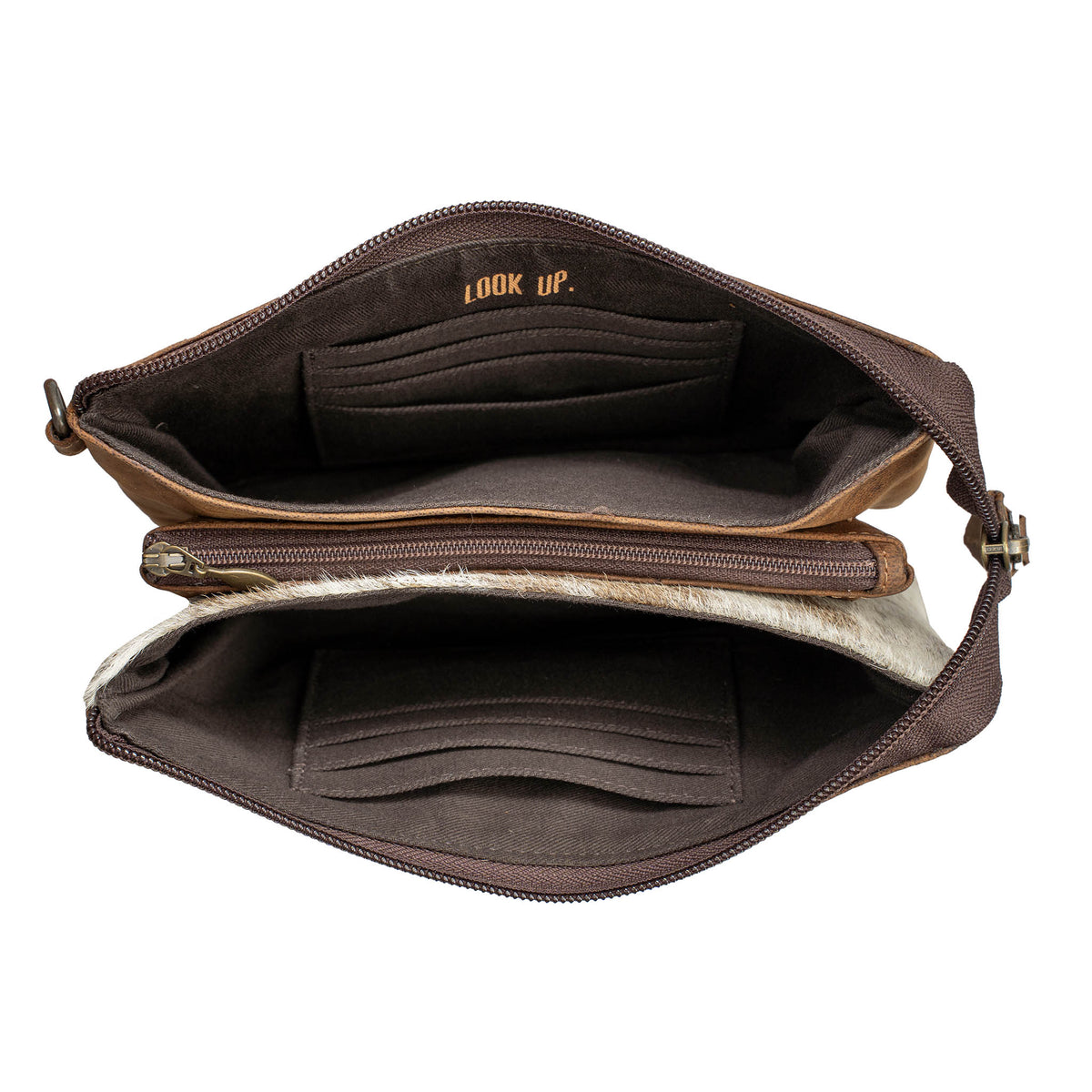 Both side compartments of a cowhide and leather crossbody purse on a white background.