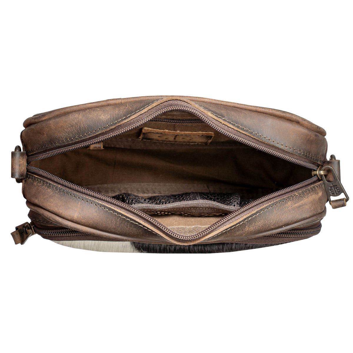 Open top view of a cowhide and leather purse on a white background