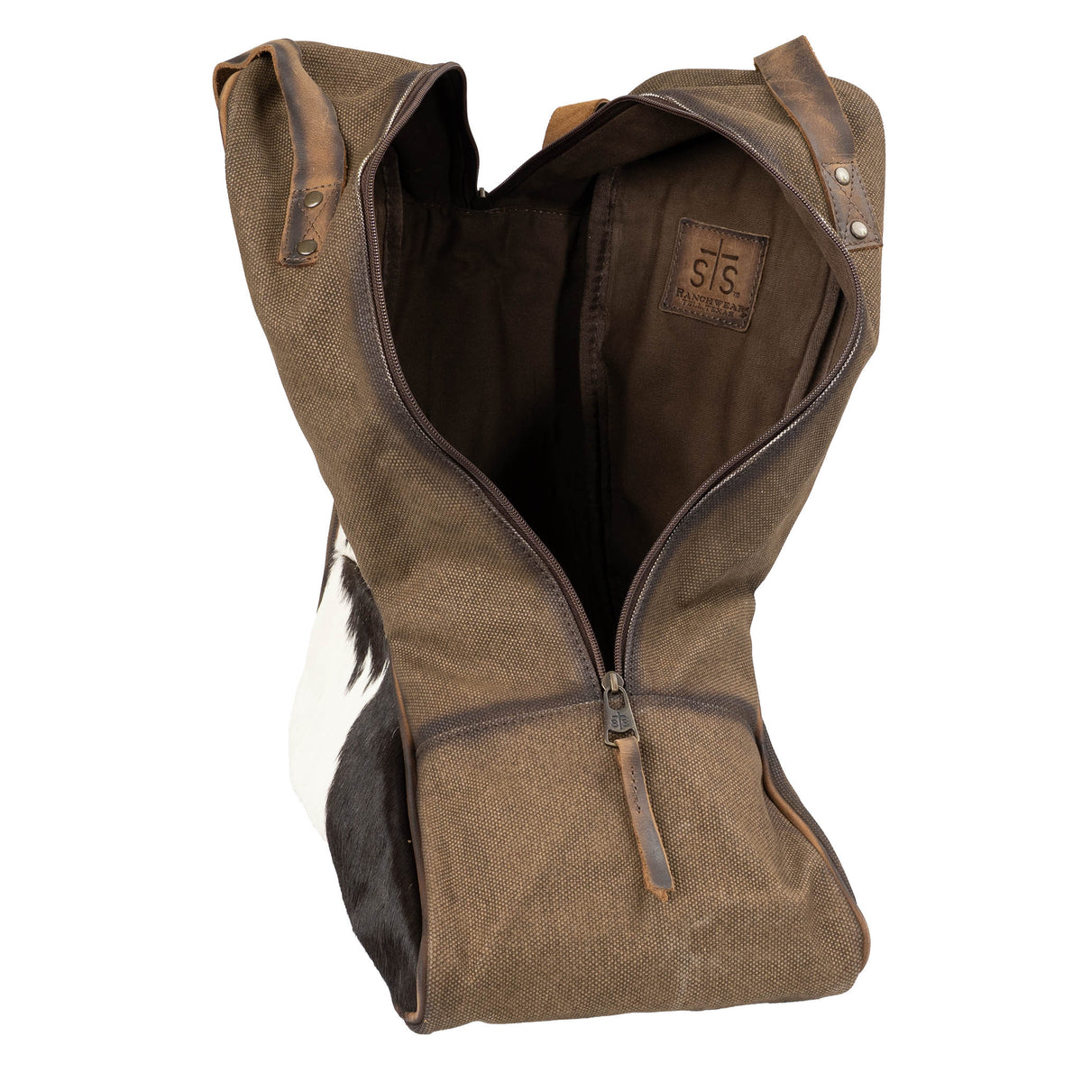 Sling cowboy boot bag with cowhide hair on hide shell, 1 zip closure pocket and leather carrying handle on a white background.