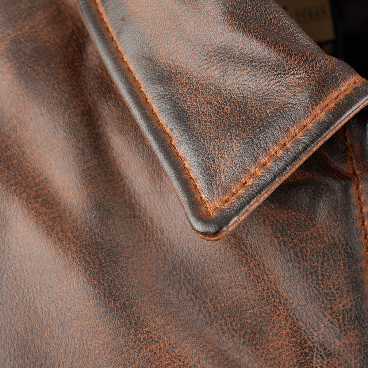 closeup of the collar on our deep bay leather jacket with a front zipper, classic western yoke and hand warming pockets on white background