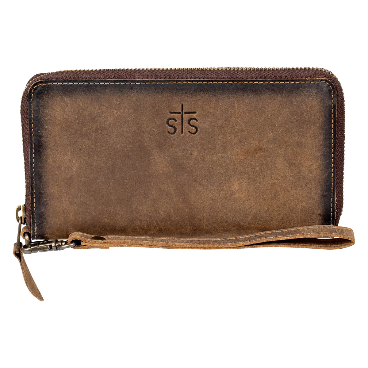 An STS embossed leather wristlet with zip around closure on a white background.