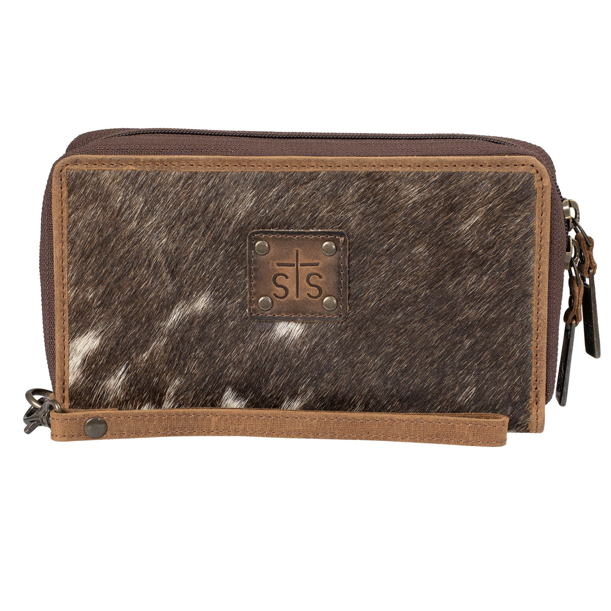Brown genuine leather wallet with cowhide pattern hair on hide exterior, leather wristlet strap, zip around closure  and visible STS branded leather patch on a white background.