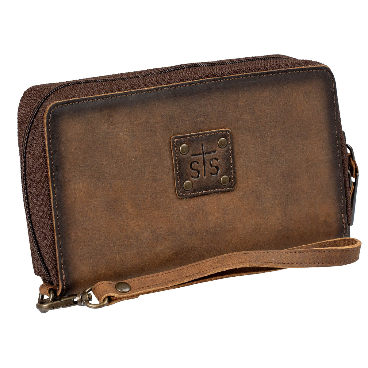 Brown genuine leather wallet with zip around closure, leather STS branded patch and leather wristlet strap on a white background.