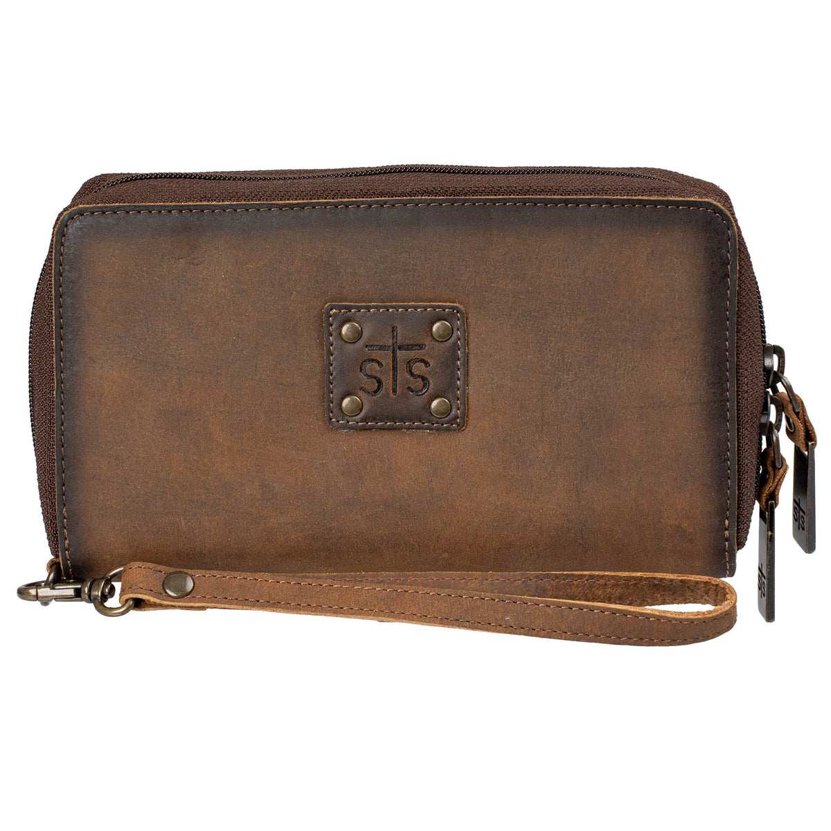 Brown genuine leather wallet with zip around closure, leather STS branded patch and leather wristlet strap on a white background.